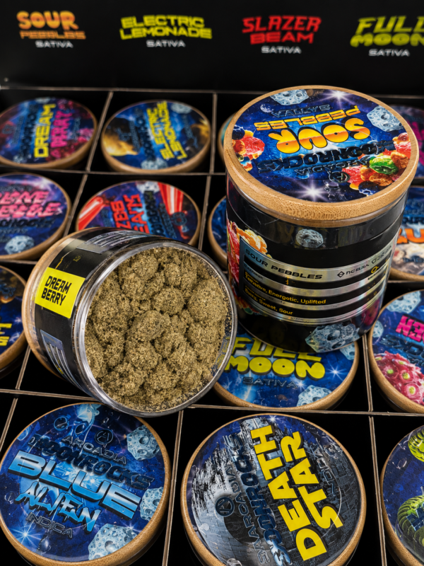 Arcadia MoonRocks collector case open showing 16 strain-specific jars in a 4x4 grid and inside-lid strain menu listing all Hybrid, Indica and Sativa options including MAC 10, Skywalker OG, Northern Lights, Sour Pebbles and Full Moon.